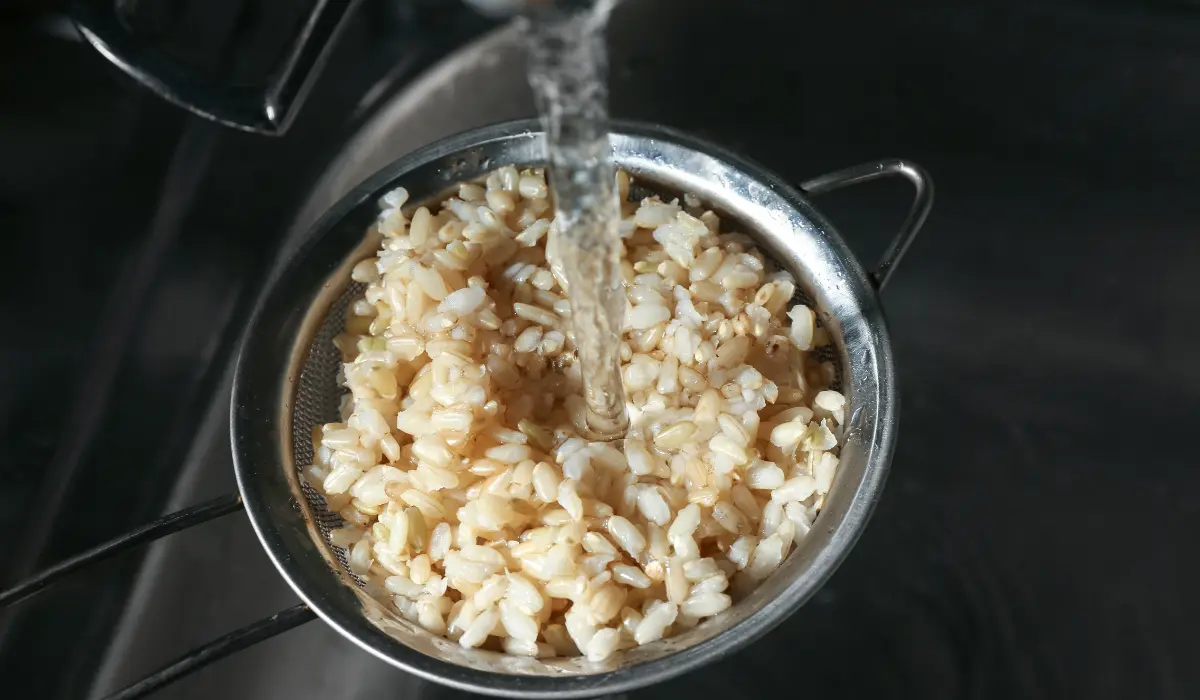 Washing Brown Rice with Water in Sieve